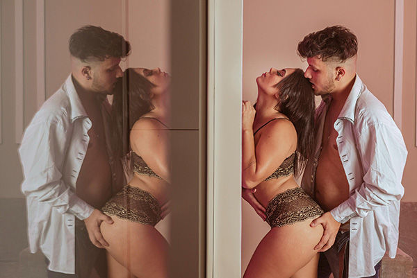 man and woman in sexual hold against mirror