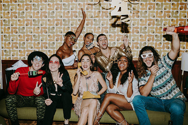 group of happy young people posing for a group photo celebrating